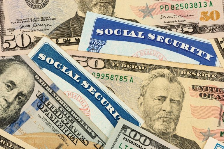 Pictured: social security cards and dollar bills